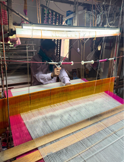 Handloom weaver working on a traditional loom using natural fibres, creating sustainable and ethical handloom clothing | Banbithi Boutique